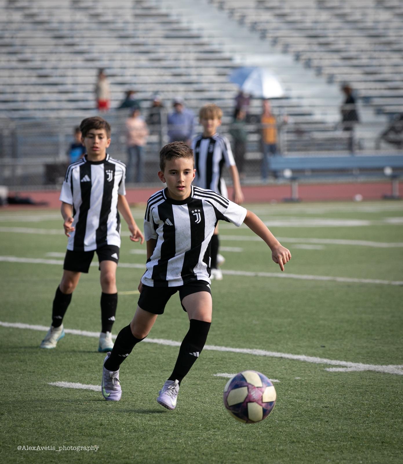 A Juventus Academy Phoenix player on the pitch in full kit