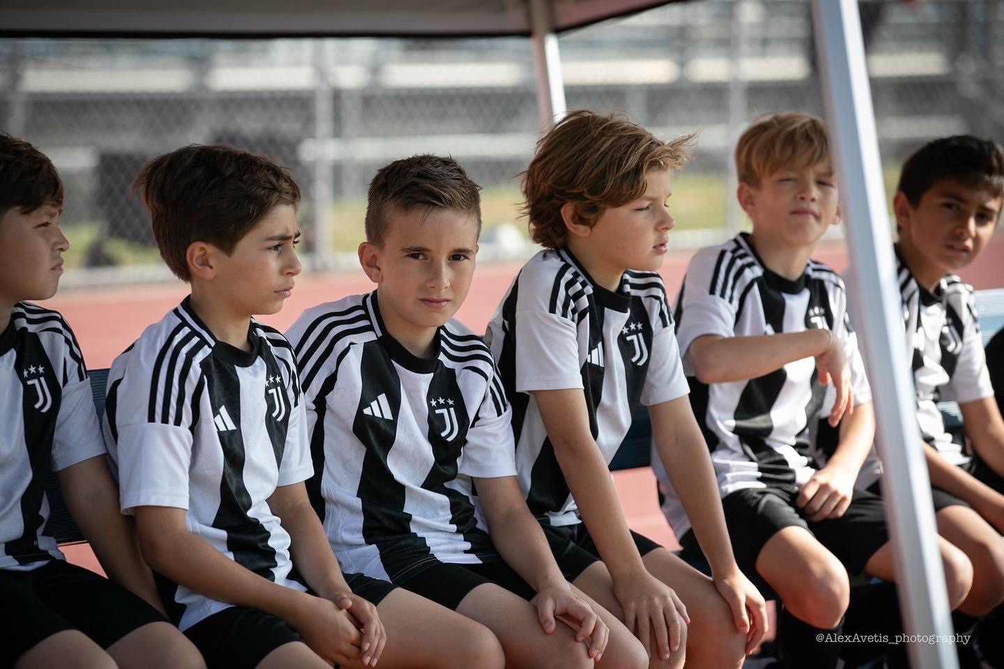 Juventus Academy Phoenix players on the bench in full kit