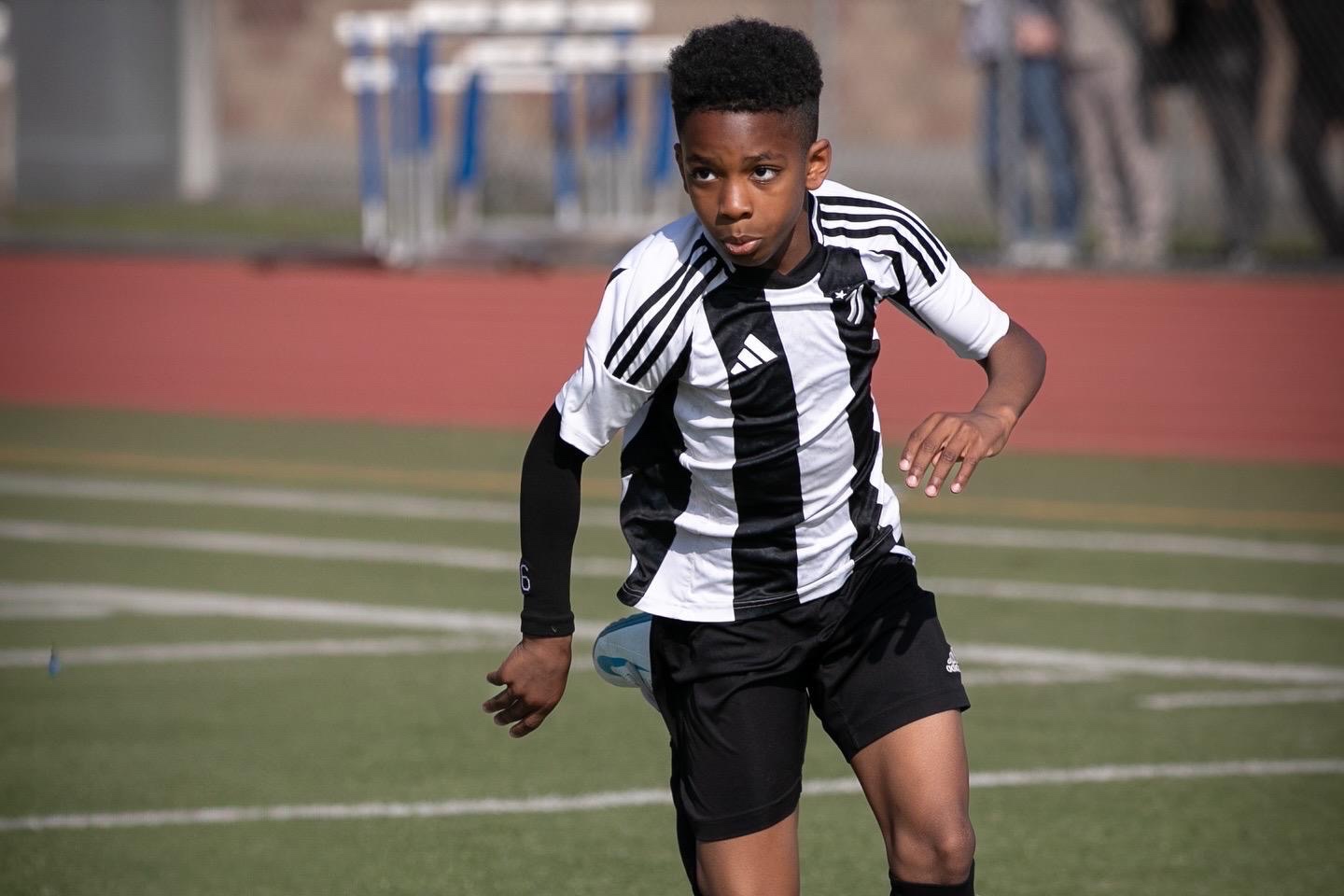 Juventus Academy Phoenix player sprinting on the track